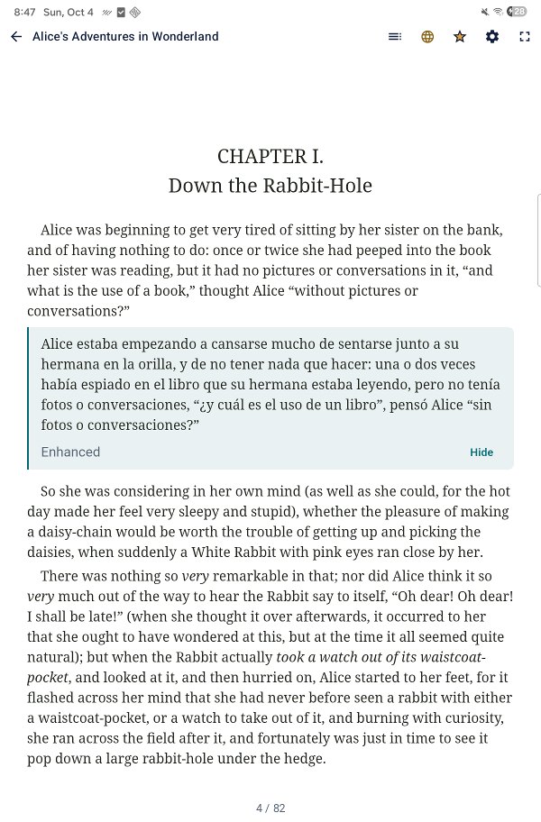 A tablet showing Chapter I of Alice's Adventures in Wonderland with the first paragraph's Spanish translation shown directly beneath it.